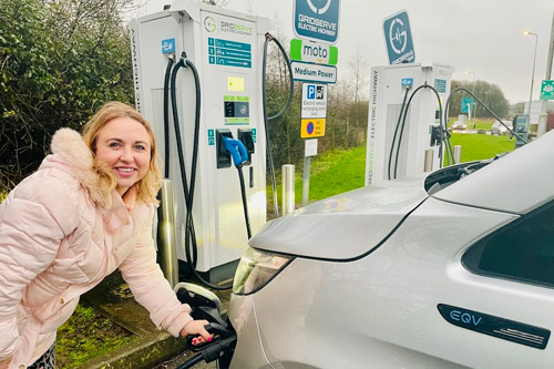 IYASU founder Catherine Embracing Sustainable Living by recharging her electric car