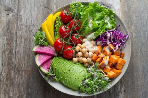 Embracing Sustainable Living: a plate full of colourful fresh vegetables and herbs